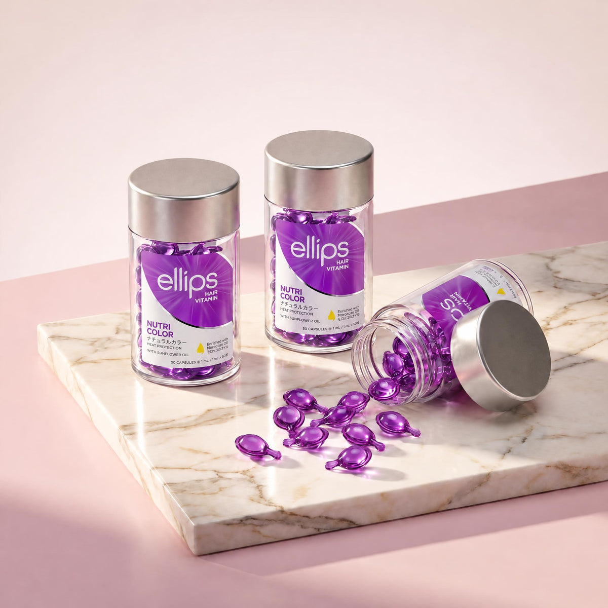 Ellips Nutri Color jars on marble, violet capsules spilling from an open jar