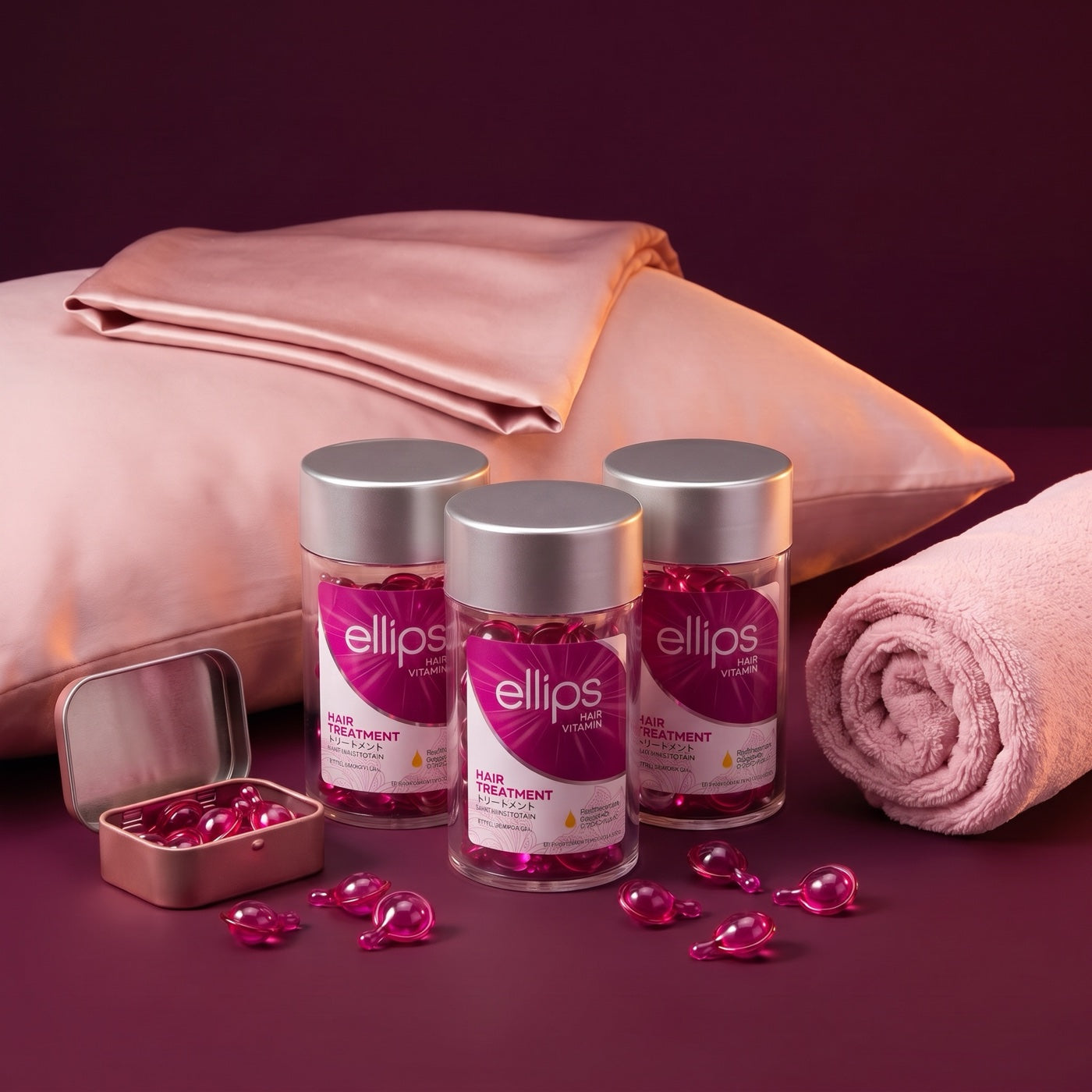 Ellips Hair Vitamin jars and capsules, styled with a pillowcase, towel and tin